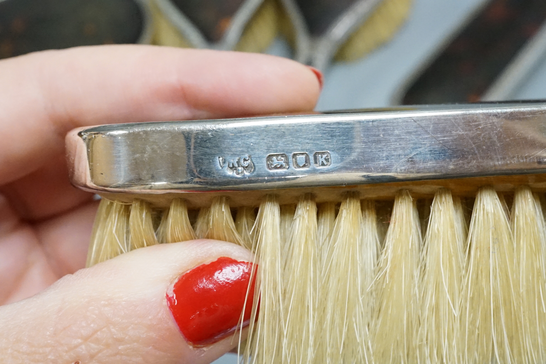 A 1940's silver and tortoiseshell mounted five piece mirror and brush set.